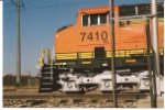 BNSF 7410 close up and personnel as she rolls south.